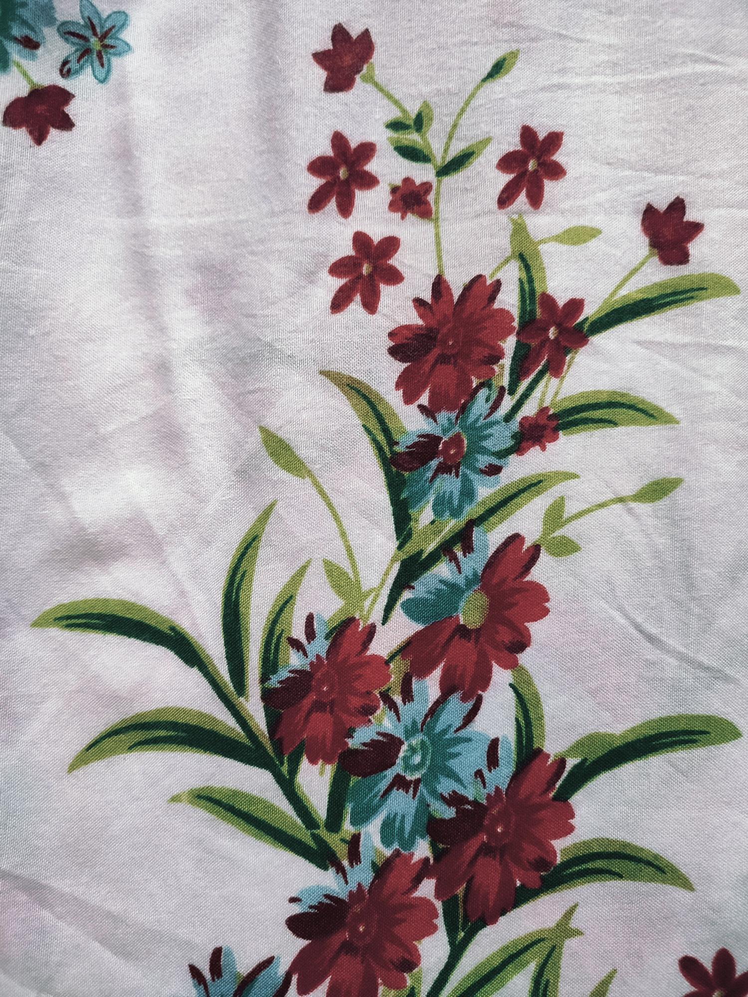 Large embroidered botanical motif on linen